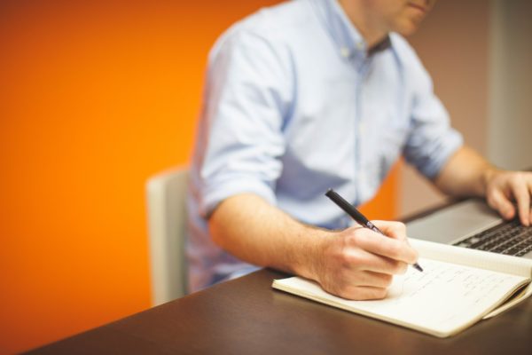 IT consultant taking notes on a call